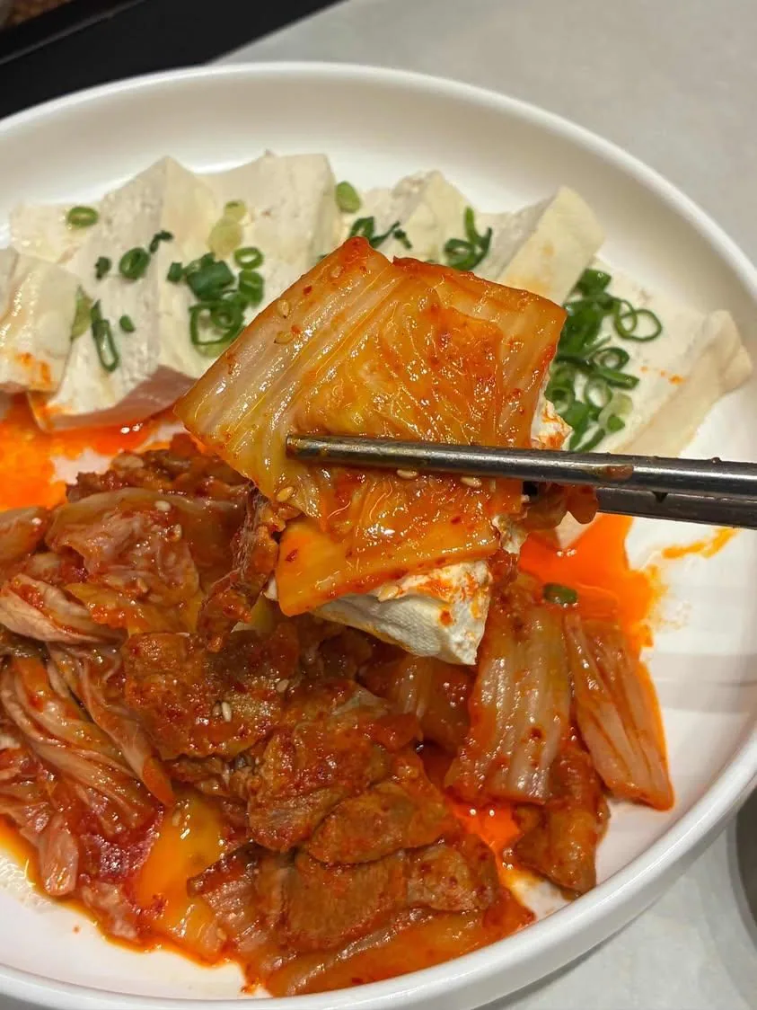 Stir-fried kimchi served on tofu